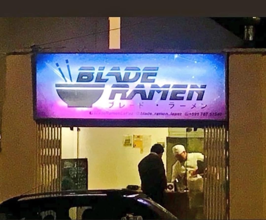 This meme is a screenshot of a restaurant called "Blade Ramen" with a sign that says "We don't care about your feelings." The image is likely a humorous take on the popular sci-fi movie "Blade Runner" and the phrase "blade" is a play on words with "ramen," a type of Japanese noodle soup. The sign's message is a satirical commentary on the restaurant's attitude towards its customers.